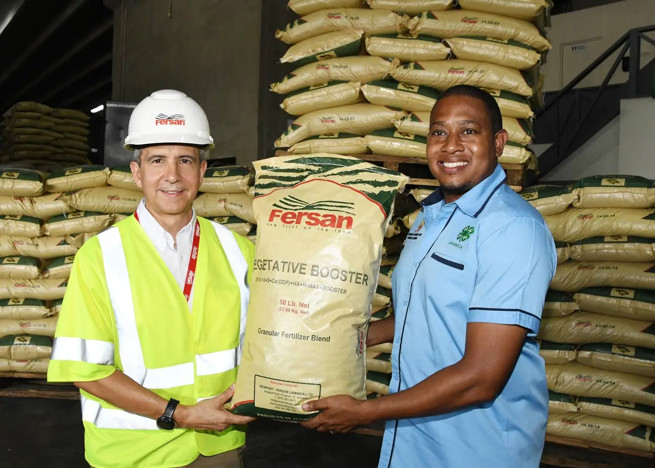 Dennis Valdez (left), managing director of Newport Fersan Jamaica Limited, and Floyd Green, minister of agriculture, at the handing over ceremony of 3,000 fertilisers to assist farmers in their recovery against the impact of Hurricane Beryl.Joseph Wellington