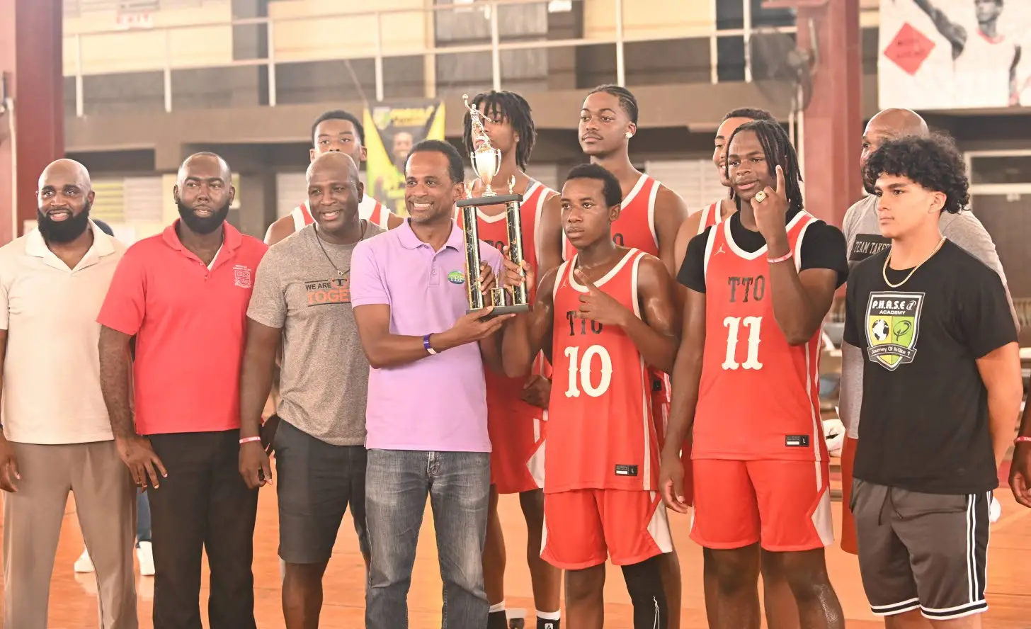 Tourism Development Fund (TEF) Executive Director Dr Carey Wallace (centre) presents the championships trophy to Julio Smith of Team Takeover after they won the JamRockerz Basketball Classic held at Montego Bay Community College on Sunday. Also in the photo (from left) are Wayne Dawkins, global director and coach for P.H.A.S.E.1 Academy; Charles Ramsey, Montego Bay Community College; Assistant Coach Marvin Riley, Team Takeover; Cole Riley; and Kingston Marley.Paul Reid