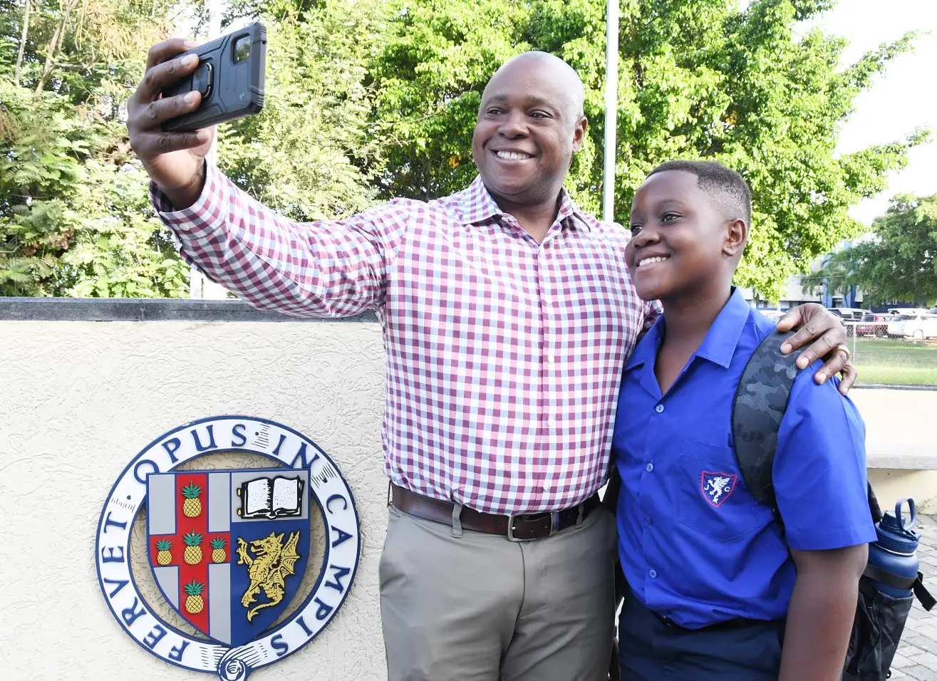 Joshua Walker and his father Miguel Walker take an ussie on his first day of school at Jamaica College in St Andrew. Miguel attended Jamaica College in 1985. Joseph wellington