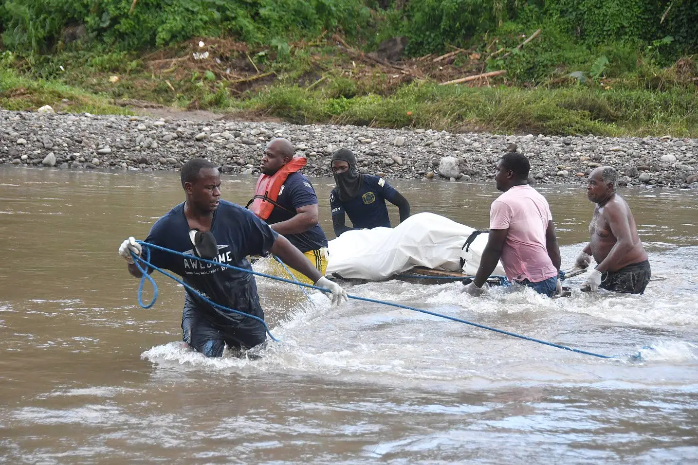 These men carry Chrisan Steele’s body across this river in St Mary on September 14. The body was found by a farmer two days after Steele and her friend Omar Skyers were swept away in the Wag Water River at Castleton, St Mary.Photo: Garfield Robinson