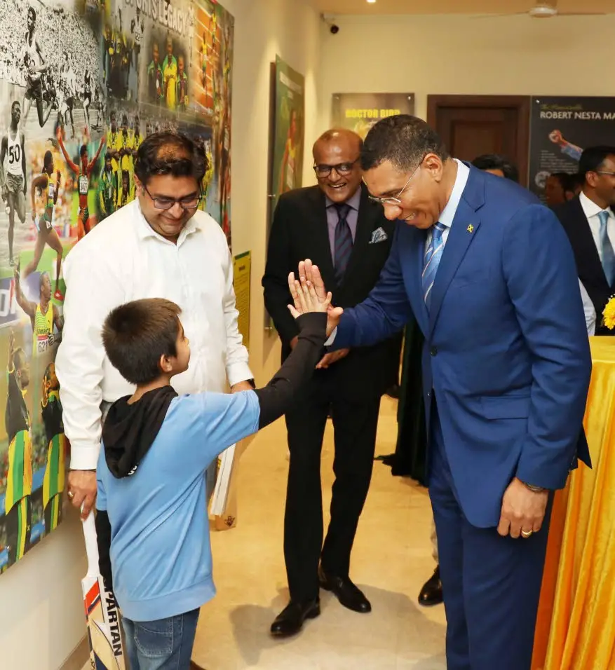 Jamaica’s Prime Minister Andrew Holness gets a high-five greeting from this boy at a reception in New Delhi on Monday. Holness is leading a Jamaican delegation on a four-day working visit to India aimed at solidifying bilateral relations. He is the first Jamaican prime minister to embark on such a visit to the South Asian country.