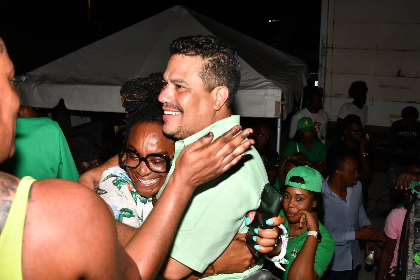 Matthew Samuda gets a congratulatory hug after winning the St Ann North Eastern parliamentary by-election on Monday.